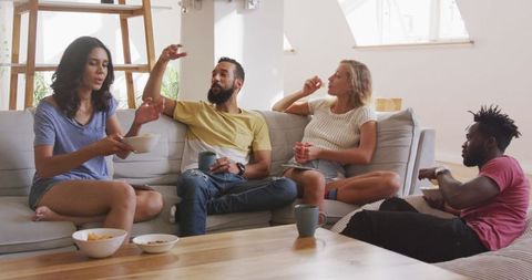 Friends Relaxing Together at Home Enjoying Snacks and Conversations