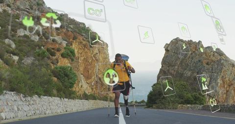 Amputee hiker trekking coastal road with prosthetic leg, backpack and green energy icons