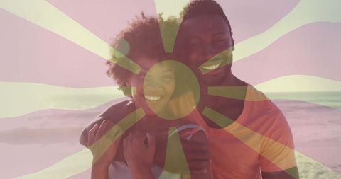 Smiling Couple Embracing at Sunset Beach with Sun Overlay