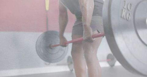 Athlete Performing Deadlift with Red Barbell and 10KG Plates, Strength Training Focus