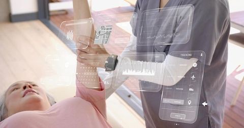 Senior undergoing AR arm rehabilitation with therapist using digital interactive interface