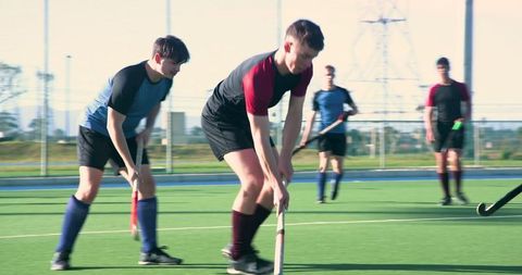 Dynamic Field Hockey Match with Teenage Boys Playing