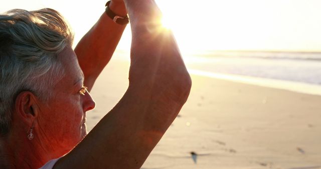 Senior Woman Meditating at Beach During Sunset - Download Free Stock Images Pikwizard.com