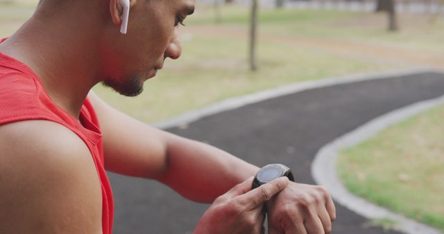 Man Checking Smartwatch During Outdoor Workout - Download Free Stock Images Pikwizard.com