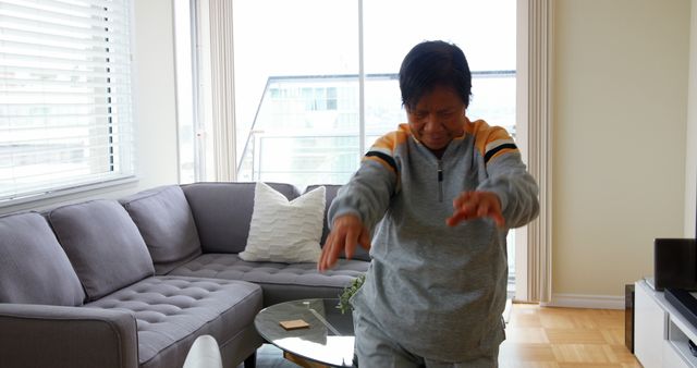 Senior Woman Practicing Tai Chi in Modern Living Room - Download Free Stock Images Pikwizard.com