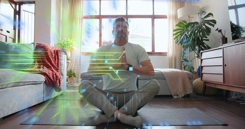 Mature man meditating at home wearing smartwatch with ar wellness overlays