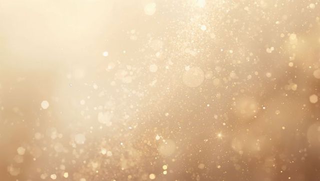 Glittering golden bokeh backdrop with soft glow, sparkling orbs and warm radiant dust