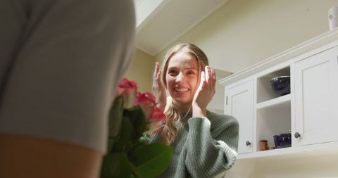 Joyful Woman Receiving Flowers at Home from Partner