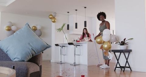 Couple Cleaning Post-Party Celebration at Home