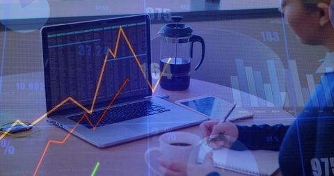 Analyzing Stock Market Trends with Laptop and Notes