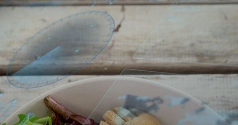 Futuristic ar salad bowl on rustic wood table with lettuce, croutons and wooden utensil