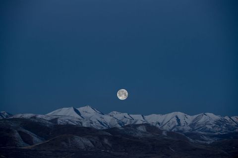 Full Moon Over Snow-Capped Mountain Range at Dusk