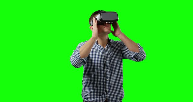 Man Exploring Virtual Reality with VR Headset on Green Screen Background - Download Free Stock Images Pikwizard.com