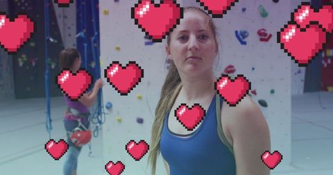 Confident Woman Climber With Digital Hearts at Gym