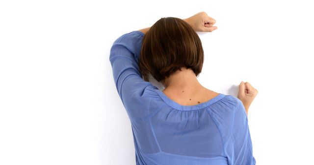 Woman Leaning Against Wall in Frustration - Download Free Stock Images Pikwizard.com