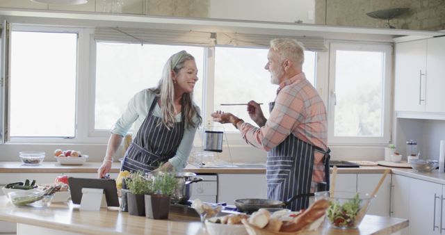 Middle Aged Caucasian Couple Cooking Together in Home Kitchen - Download Free Stock Images Pikwizard.com