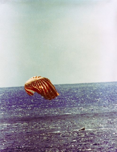 Historical depiction of Gemini-11 landing with parachute in Atlantic Ocean. Useful for educational content on space missions, aerospace achievements, or historical events. Ideal for articles, presentations, and documentaries on space exploration and NASA history.