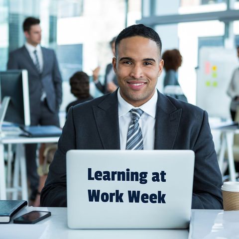 professional smiling at desk during learning at work week - Download Free Stock Templates Pikwizard.com