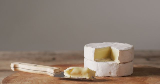 Two Camembert Cheese Wheels with a Sliced Piece on Wooden Board - Download Free Stock Images Pikwizard.com