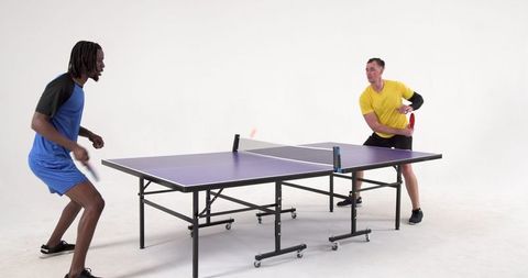Pro athletes in energetic table tennis duel action