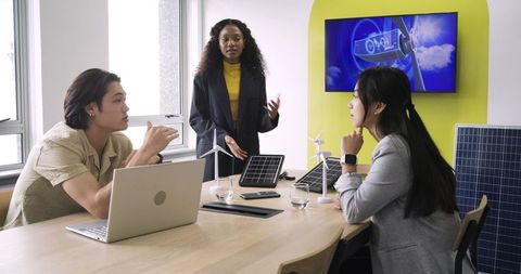 Sustainable energy strategy meeting with diverse team collaborating