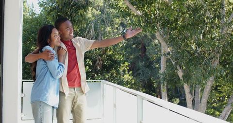Couple Enjoying Outdoor Nature View From Balcony