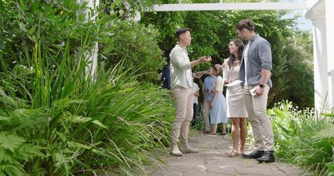 Guests Enjoying Lush Green Garden Wedding Celebration