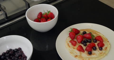 Delicious Crepe Topped with Fresh Berries in Kitchen