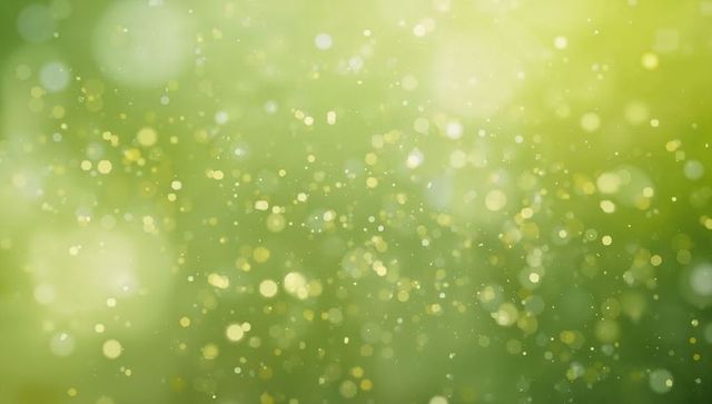Shimmering green bokeh with golden sparkles and floating light orbs