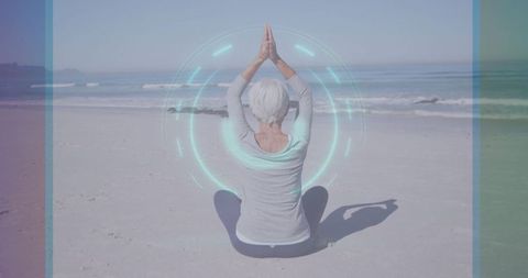 Senior Woman Meditating on Beach with Digital Holograph