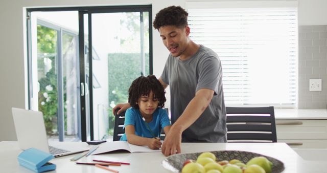 Father assists young child with homework at home, showcasing elements of modern parenting, educational support and family bonding. Useful for illustrations of home tutoring, parental involvement in education and promoting positive family relationships.