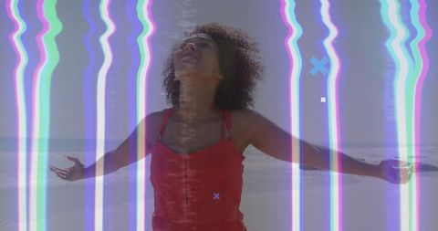 Glitch overlay with joyous woman on beach in red dress