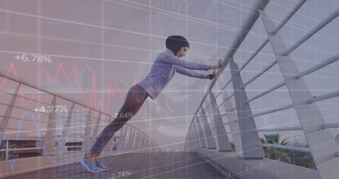 woman in hijab stretching with financial market graph overlay - Download Free Stock Images Pikwizard.com