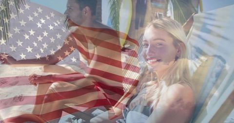 Couple enjoying beach vacation with american flag overlay