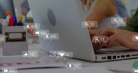 Typing on laptop amid social media notifications for marketing and coworking teamwork