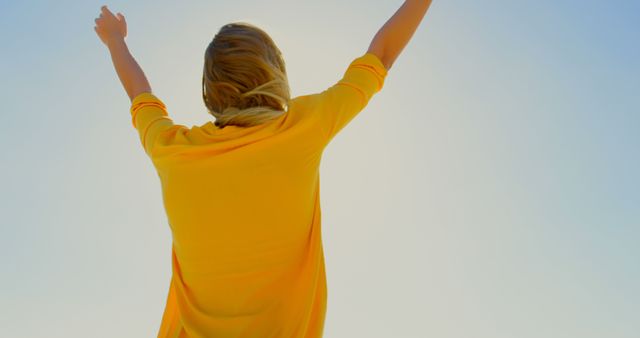 Woman Celebrating with Arms Raised Against Clear Blue Sky - Download Free Stock Images Pikwizard.com