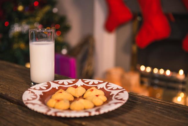 Christmas cookies on plate with a glass of milk on wooden table during christmas time