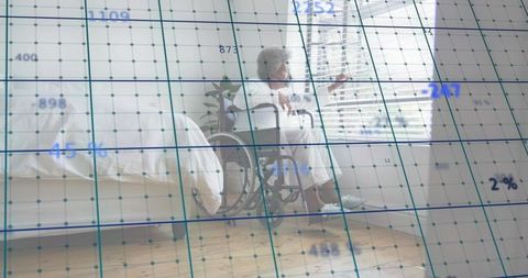 Black senior woman sitting in wheelchair by bed looking through blinds with data overlay