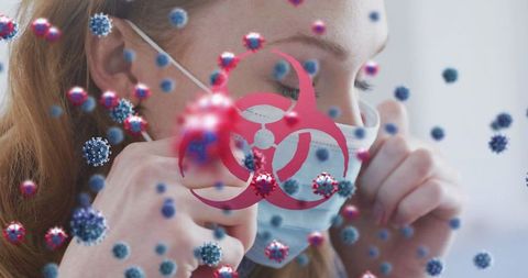 Virus cells and biohazard symbol overlaying woman with face mask