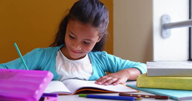 Young Girl Studying at School Desk with Books and Pencils - Download Free Stock Images Pikwizard.com