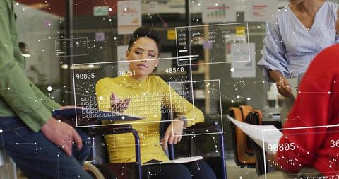 Business leader in yellow sweater using augmented reality data overlays at team meeting