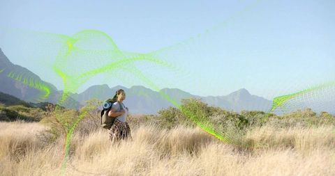 Lone Hiker Exploring Breathtaking Scenic Foothills with Neon Streaks