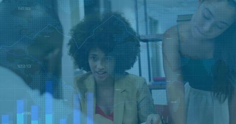 Businesswoman presenting analytics to team, pointing at laptop, discussing charts