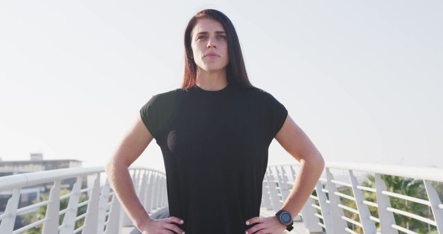 Confident Female Athlete Standing on Bridge in Morning Light - Download Free Stock Images Pikwizard.com