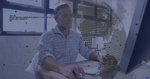 Mature man working on desktop with data overlay and analytics visualization for tech teams