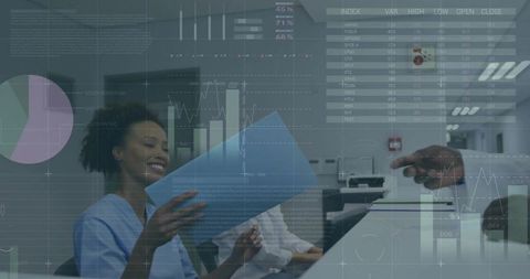Smiling businesswoman analyzing reports with digital charts