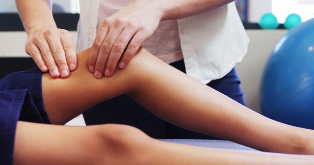 Physical therapist performing knee rehabilitation treatment on patient. Useful for websites, blogs, and articles focused on healthcare, physical therapy practices, athletic injury recovery, and wellness. Ideal for illustrating physical rehabilitation services and therapeutic massage techniques.