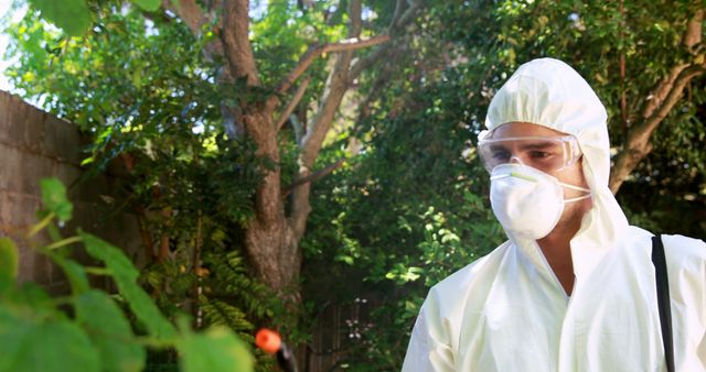 Pest Control Worker in Protective Gear Spraying Outdoors - Download Free Stock Images Pikwizard.com