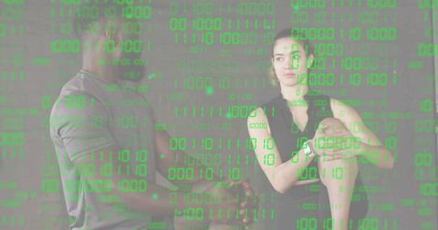 Two adults in studio wearing minimalist clothing with green binary code overlay