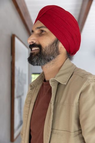 Contemplative indian man admiring art in modern home setting